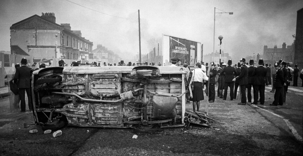Police Officers gather around a burnt out car at the fork of Railton Rd &amp; Mayall Rd