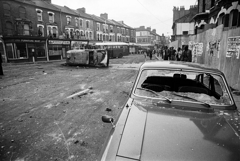 Local people survey the wreckage in Railton rd. In the early stages of the riot members of the public were surprisingly safe and wandered unhindered in areas the police couldn't get to.