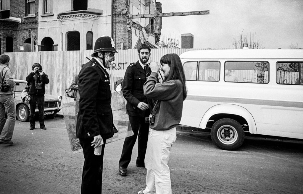 A Times photographer photographs Inspector Dennis Bell in Railton Road